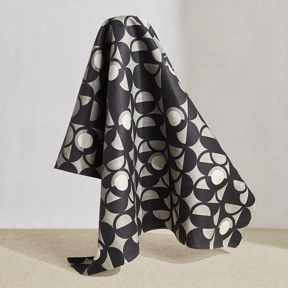 Draped fabric in a curvilinear art deco inspired pattern in black, grey and white.