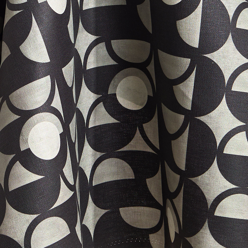 Fabric in a curvilinear art deco inspired pattern in black, grey and white.