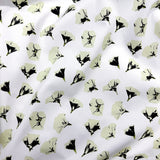 Floral patterned fabric with black and cream on a white background