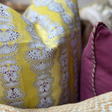 Detail of a printed yellow pillow. 