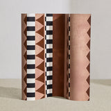Wallpaper roll in bold geometric printed fabric in brown and tan with black and white accents.