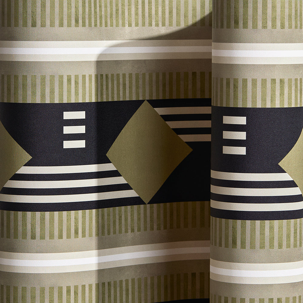 Wallpaper in a graphic geometric design in sage green, taupe, white and black.