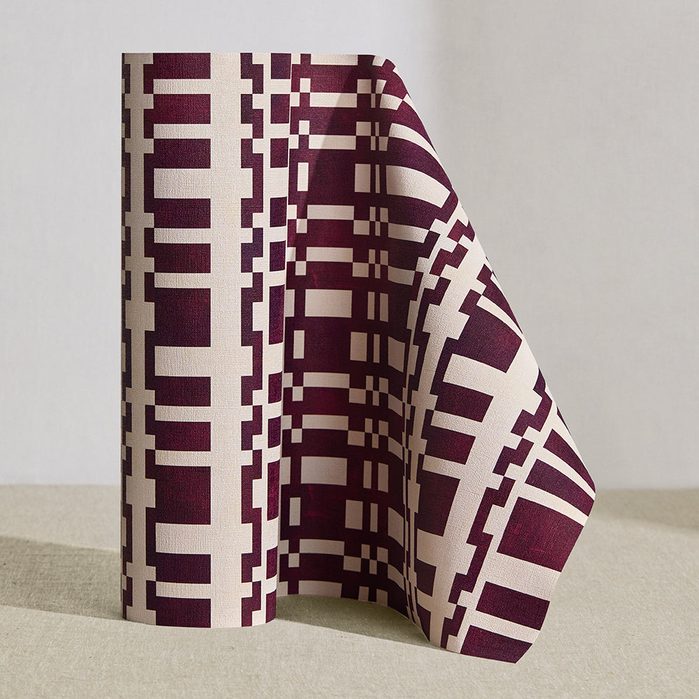 Wallpaper roll in a modernist checkerboard pattern in maroon and cream.