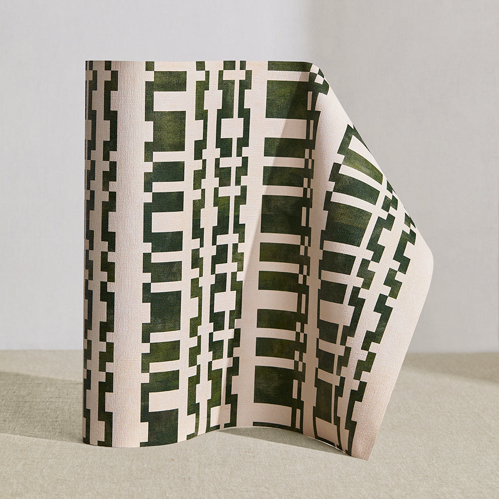 Wallpaper roll in a modernist checkerboard pattern in hunter green and cream.