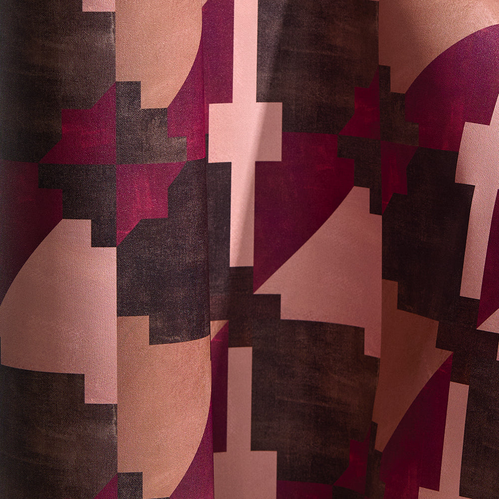 Wallpaper in a bold abstract checkerboard pattern in brown, tan, pink and fuchsia.