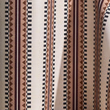 Wallpaper in a complex geometric stripe in maroon, ochre, ecru and black on a cream field.