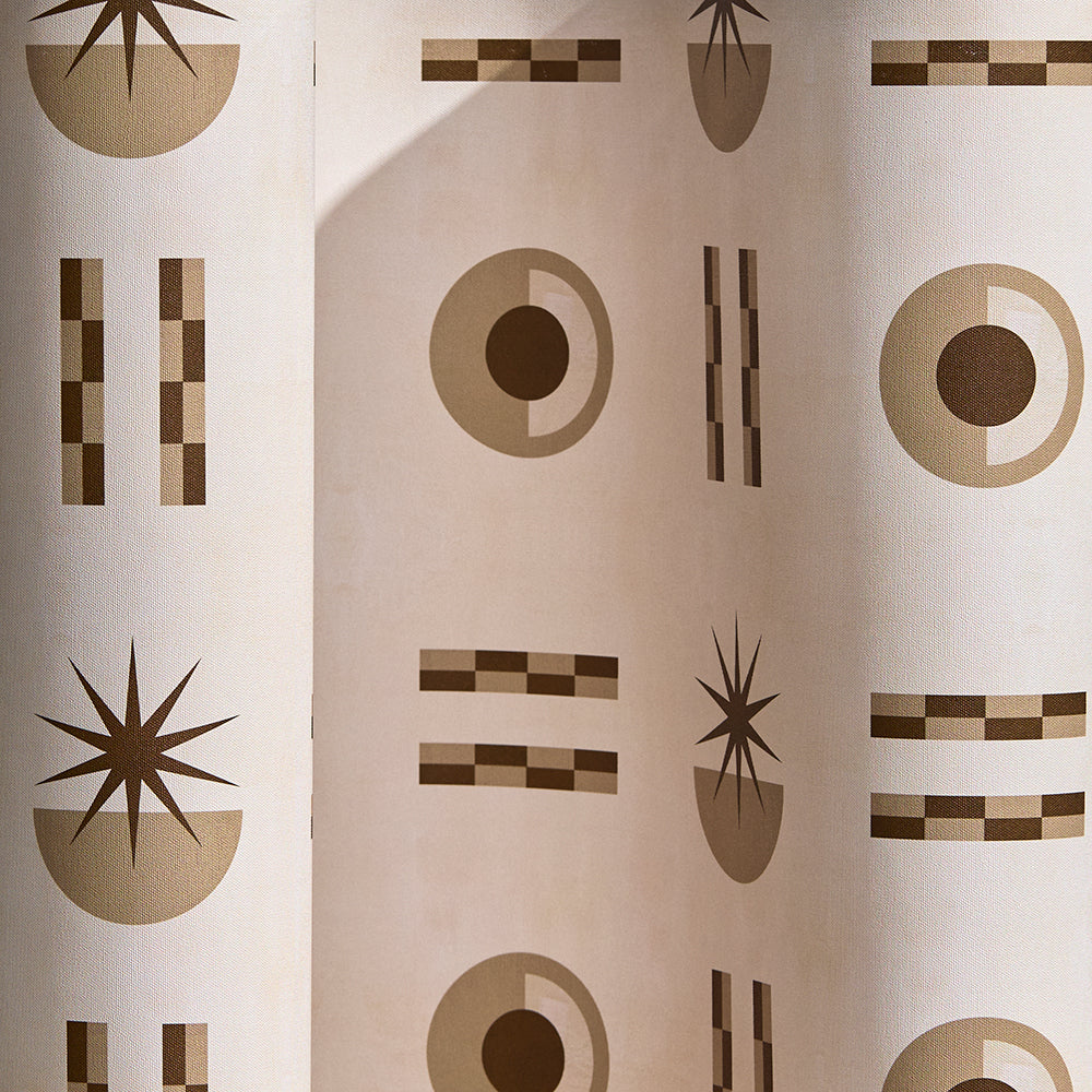  Wallpaper in a graphic geometric pattern of circles, stars and stripes in taupe and brown on a cream field.