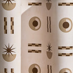  Wallpaper in a graphic geometric pattern of circles, stars and stripes in taupe and brown on a cream field.