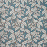 A close-up of a woven fabric pattern featuring a dense botanical leaf design in muted blue, beige, and gray tones.