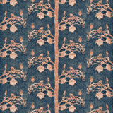 Detail of wallpaper in a linear tree and leaf print in burnt orange on a navy field.