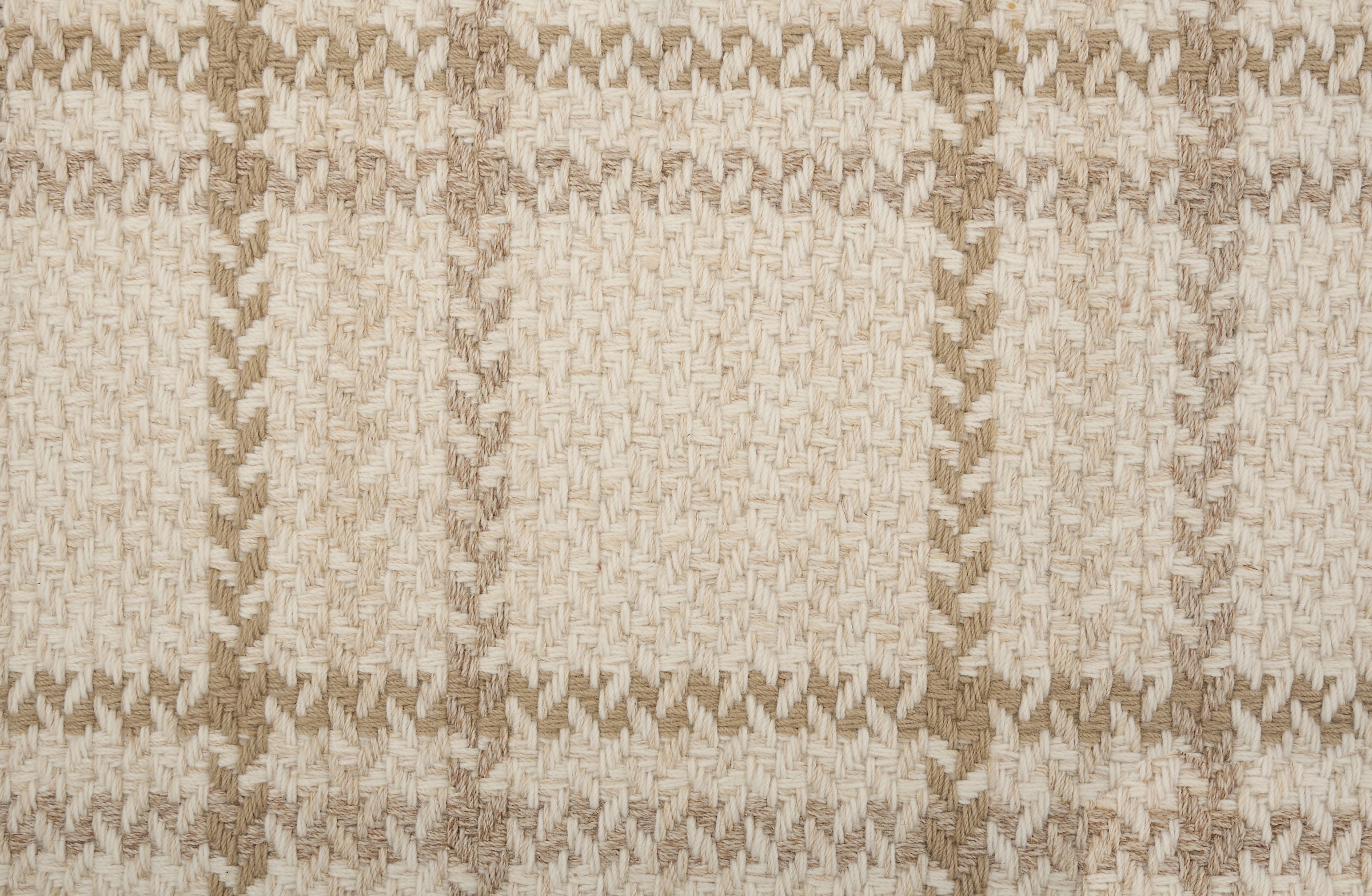 Broadloom carpet in a windowpane plaid in taupe on a beige field.