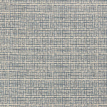 Detail of a linen fabric in a repeating abstract gridded pattern in navy on a cream field.