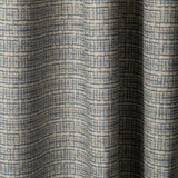 Draped linen fabric in a repeating abstract gridded pattern in navy on a cream field.