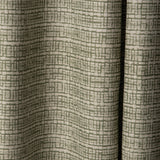 Draped linen fabric in a repeating abstract gridded pattern in sage on a cream field.