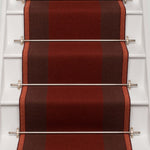 Striped flatweave runner in red and brown on white staircase