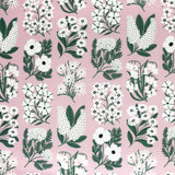 Detail of fabric in a minimalist floral grid print in white and green on a light pink field.