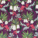 Detail of fabric in a dense floral print in shades of white, pink and green on a purple field.