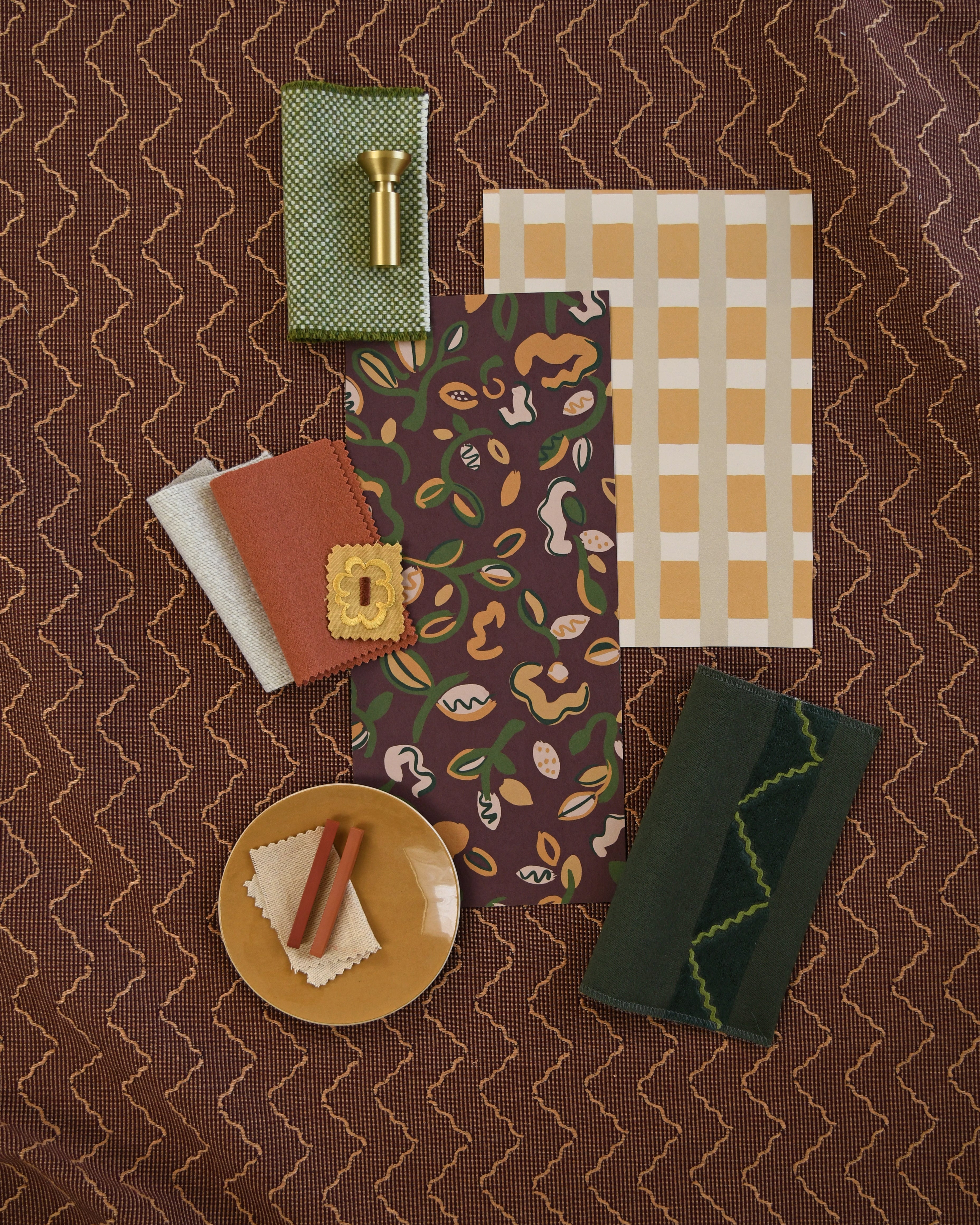 Moodboard with layered swatches of fabrics and inspiration images in palette of  brown, green and tan. 