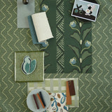 Moodboard with layered swatches of fabrics and inspiration images in palette of green
