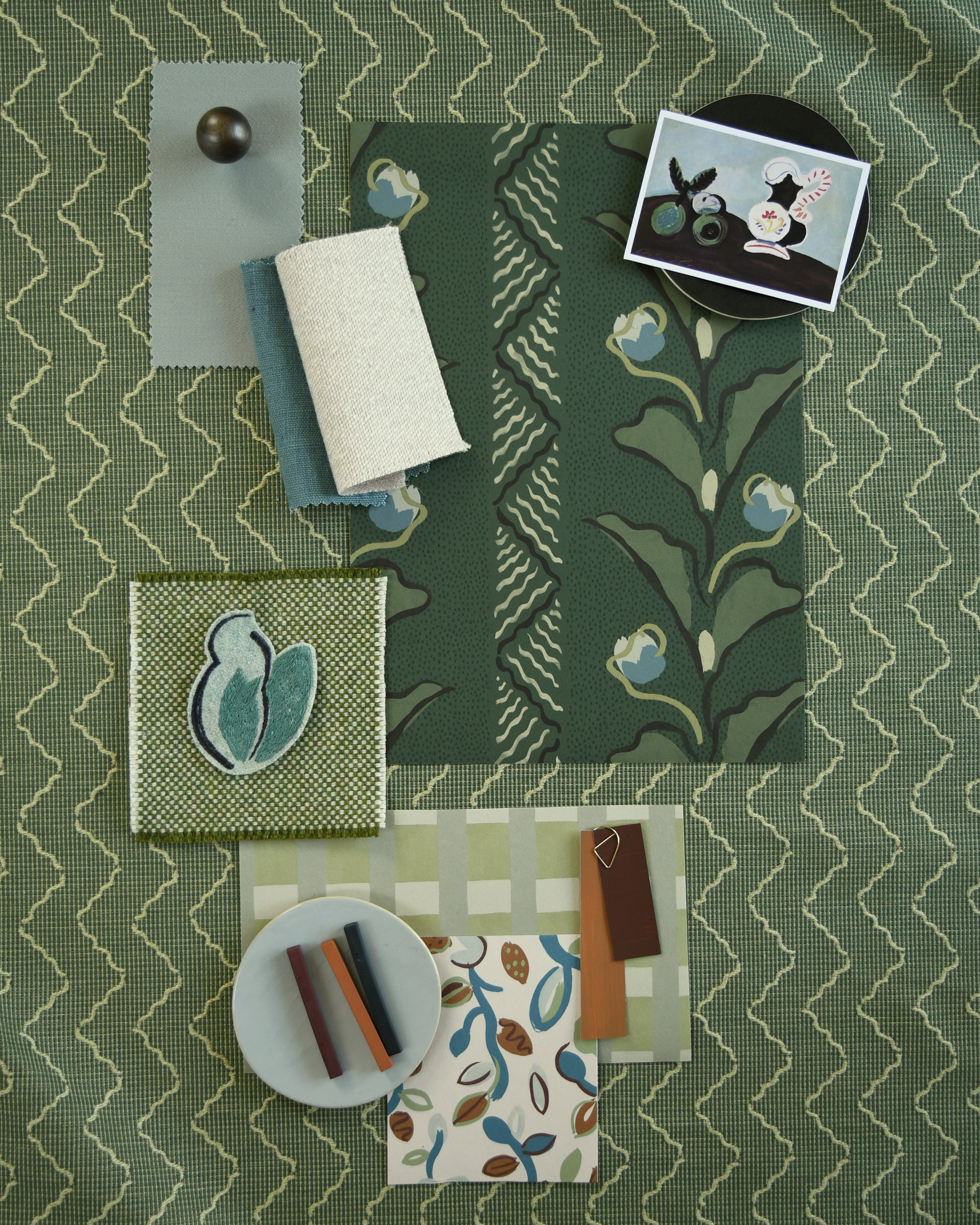Moodboard with layered swatches of fabrics and inspiration images in palette of green