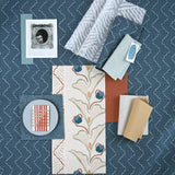Moodboard with layered swatches of fabrics and inspiration images in palette of blue. 