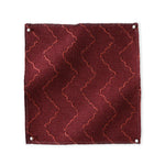 Pinned swatch of woven fabric with chevron stripe in dark red. 