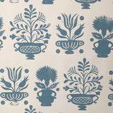 Detail of wallpaper in a repeating vase and plant print in blue on a white field.