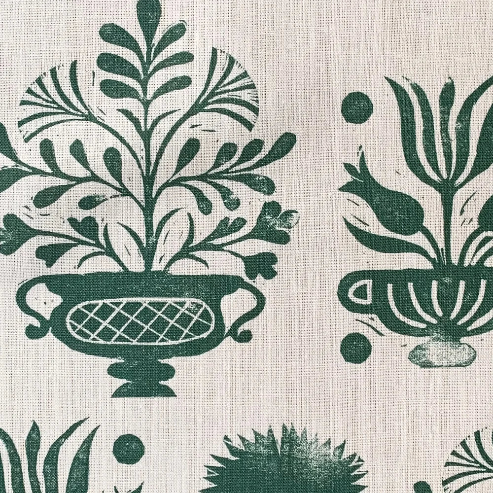 Green floral and leaf pattern on a beige background