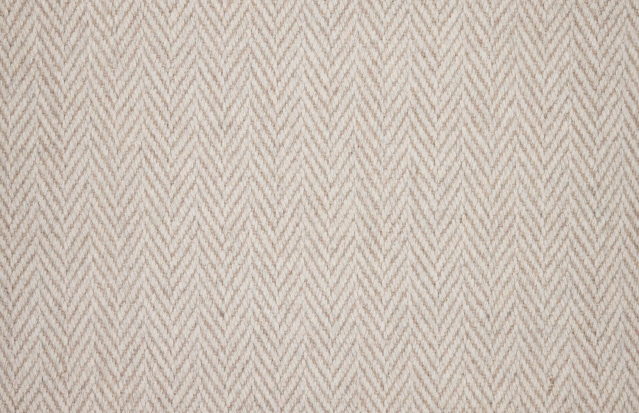 Broadloom carpet in a herringbone in cream. 