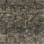 Handmade rug with a raised cut pile design in a geometric pattern in a mix of grey and tan. 