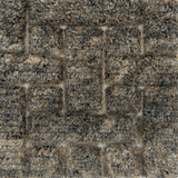 Handmade rug with a raised cut pile design in a geometric pattern in a mix of grey and tan. 