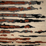Textured rug with abstract pattern in brown, black, and beige.