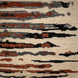 Textured rug with abstract pattern in brown, black, and beige.