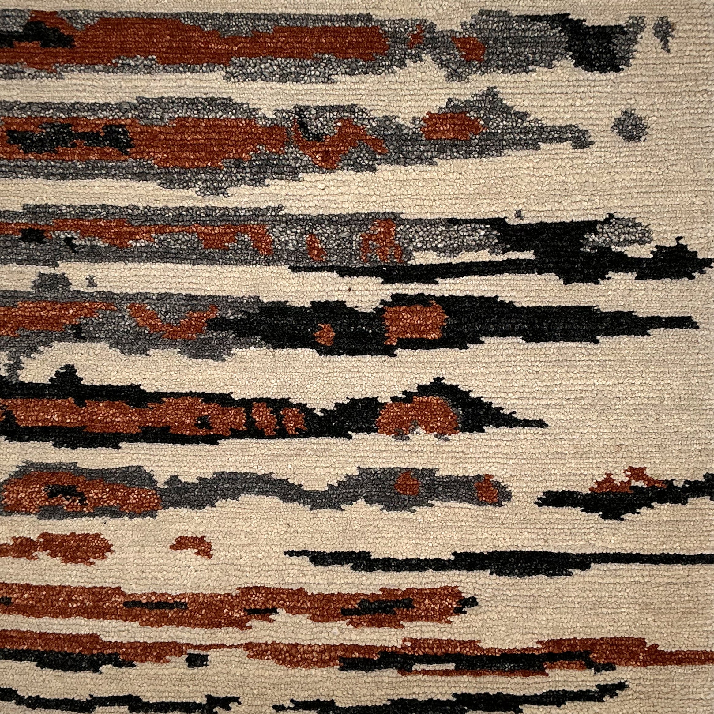 Textured rug with abstract pattern in brown, black, and beige.