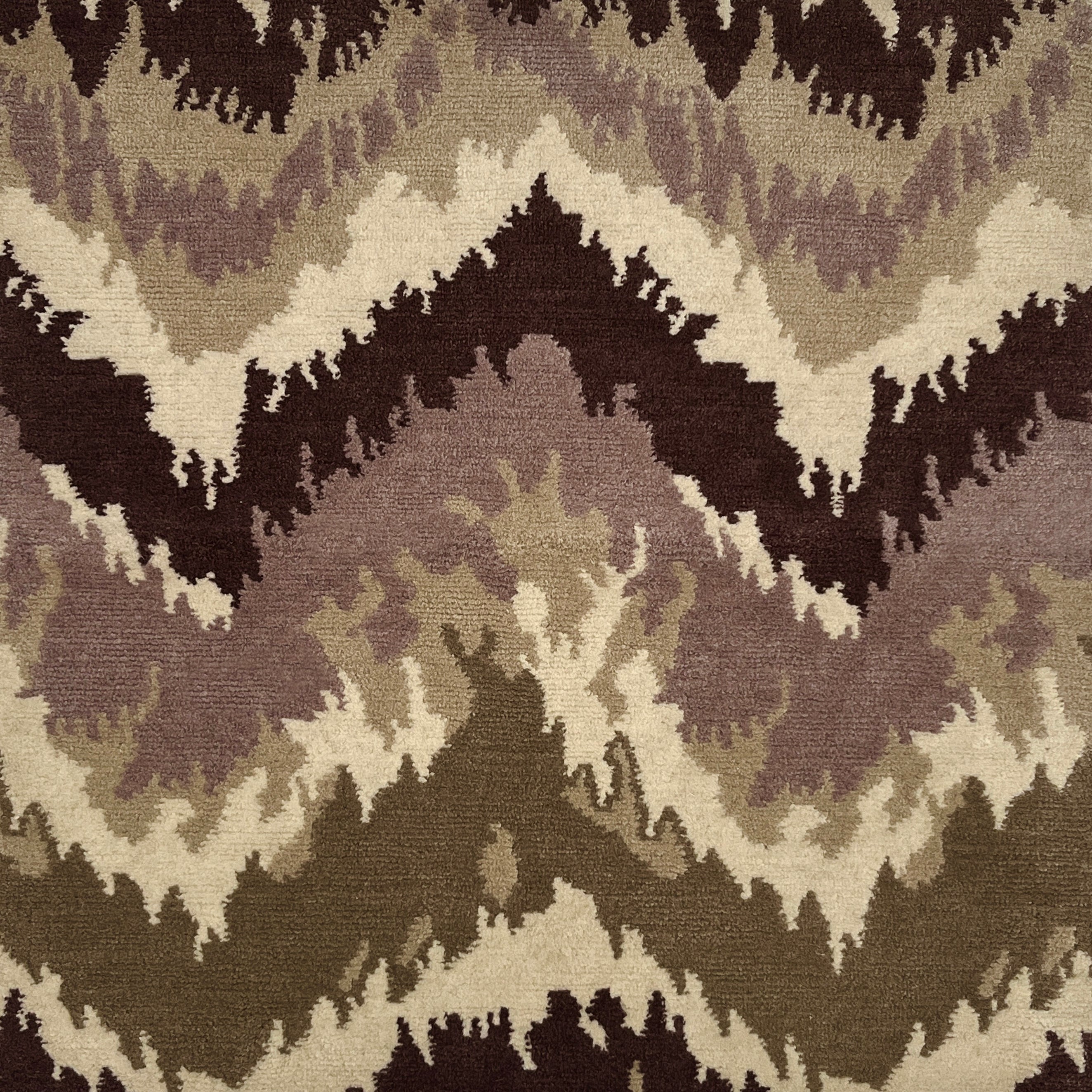 Patterned handknotted rug with zigzag design in brown, beige, and black.