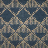 Handknotted rug in a geometric design in slate blue on a grey field. 