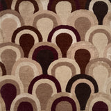 Patterned rug with scallop shapes in shades of brown, beige, and black.