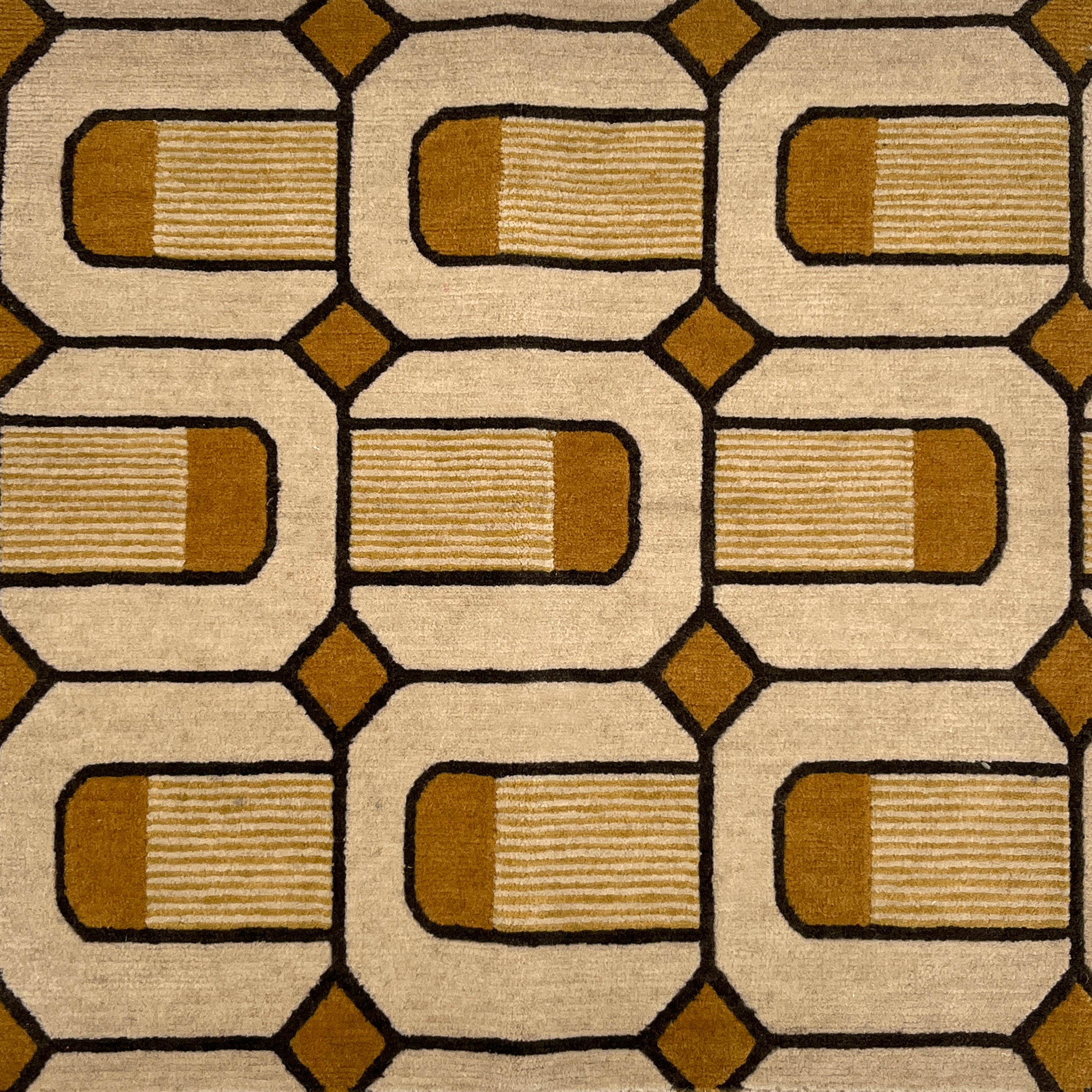 Close-up of a patterned rug with brown and beige colors