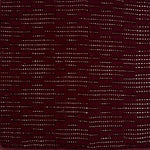 Close-up of a maroon rug with raised lattice pattern