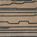Handknotted rug with an abstract line in grey on a cream field. 