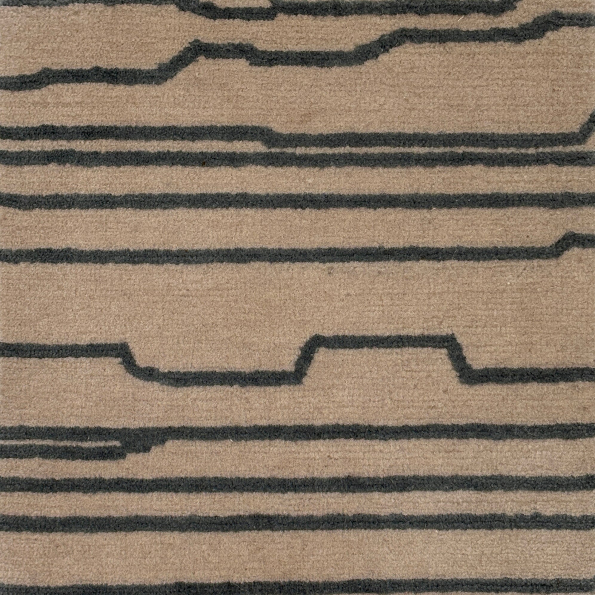 Handknotted rug with an abstract line in grey on a cream field. 