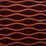 Hand knotted rug with a wavy line in orange on a maroon field. 