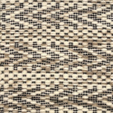 Flatweave rug with graphic herringbone pattern in cream and tan with black accents.