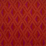 Detail of a woven high-pile rug in an interlocking diamond pattern in pink, red and orange