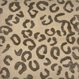 Handknotted rug with leopard spot motif in grey on cream. 