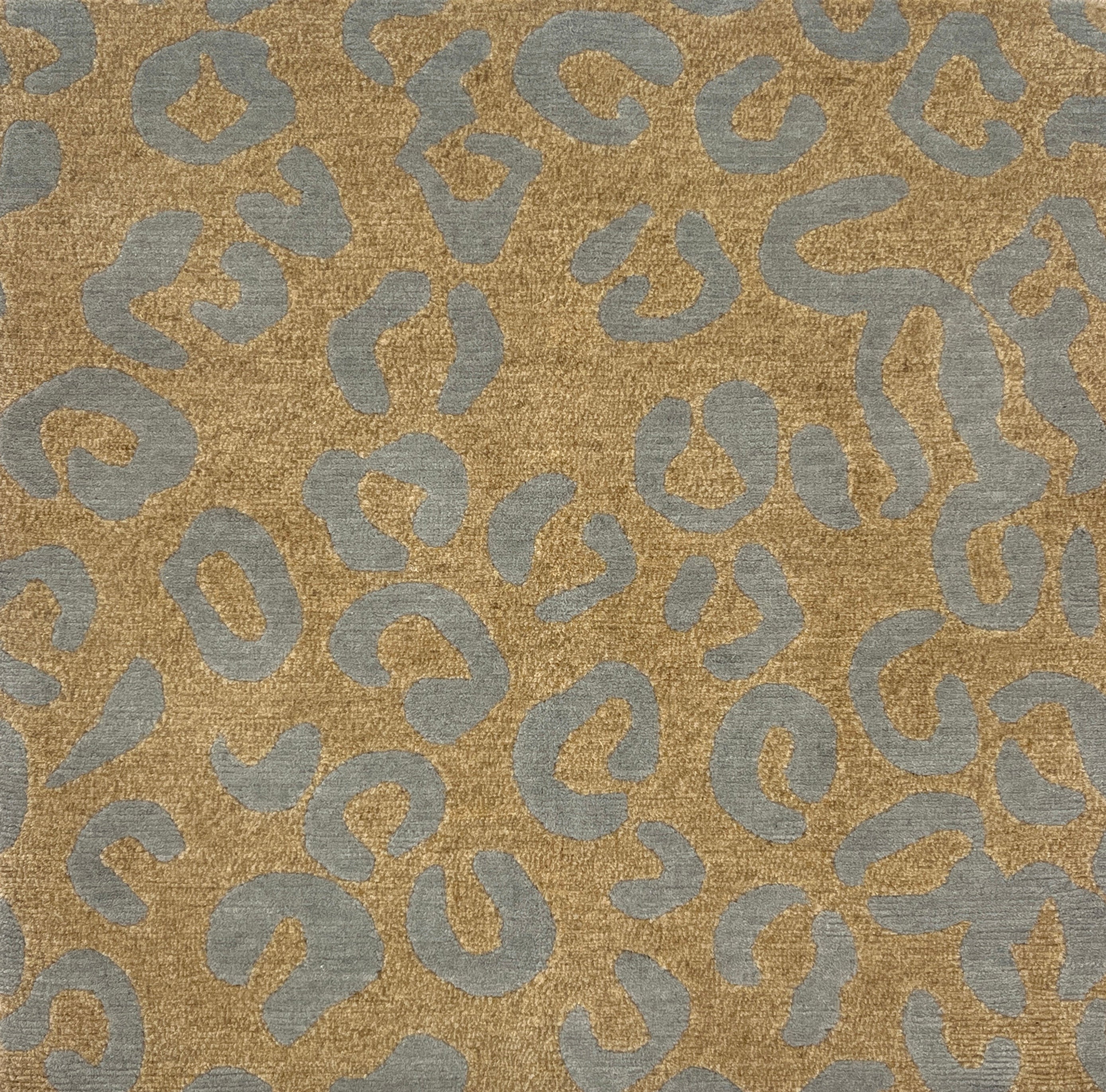 Handknotted rug with leopard spot motif in blue on tan. 