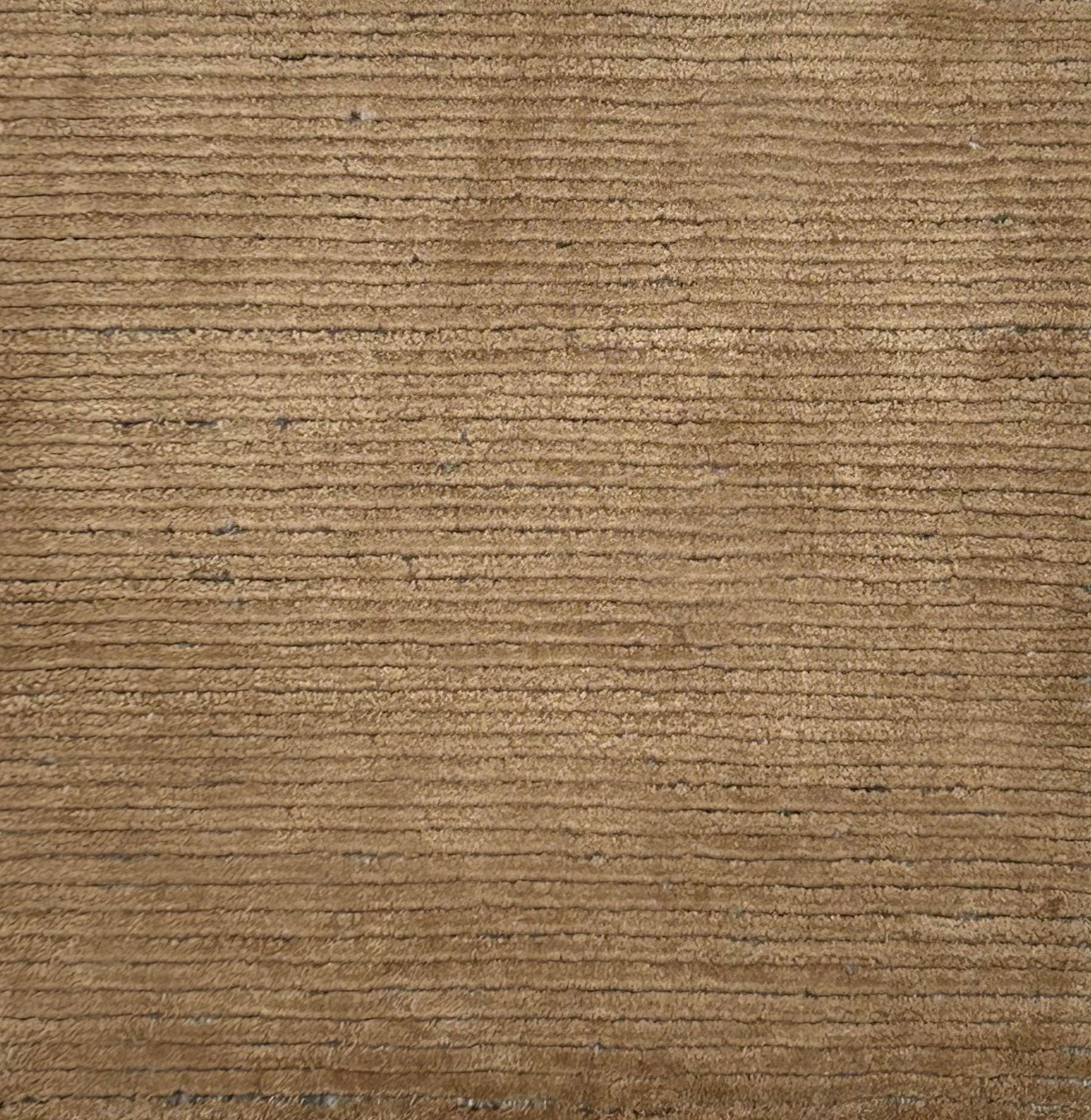 Handknotted rug in a ribbed stripe in camel.