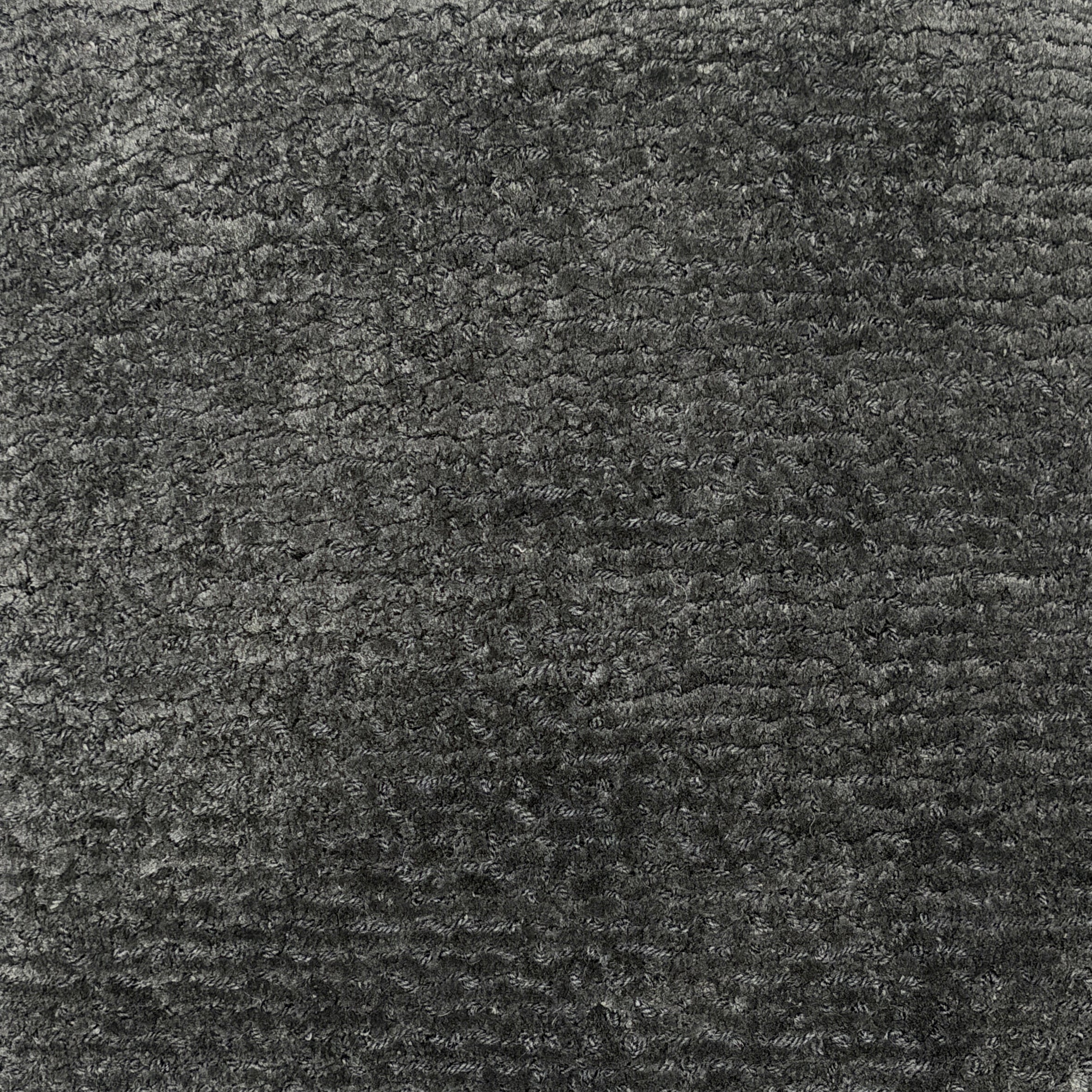 Handknotted rug in a textured solid grey.