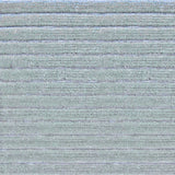 Detail of a handknotted rug in a raised stripe pattern in light grey