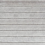 Detail of a handknotted rug in a cut pile stripe in ivory mohair.